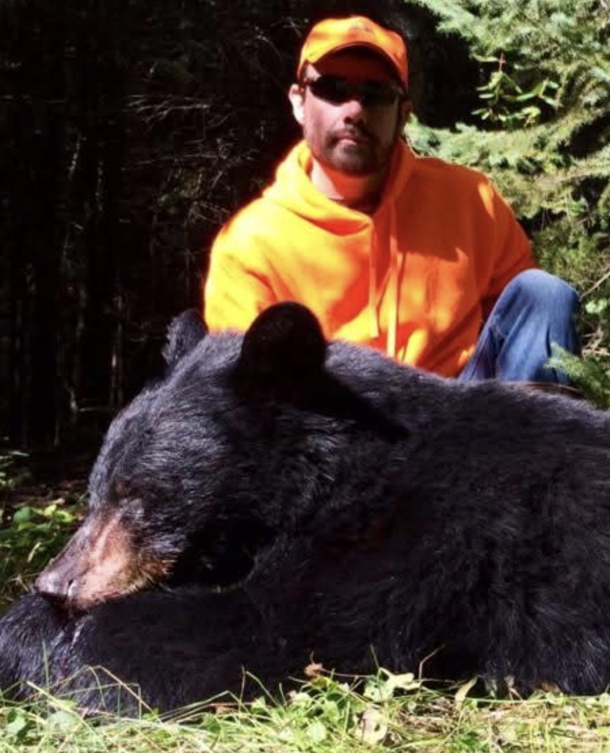 A hunter sharing a field moment with a black bear