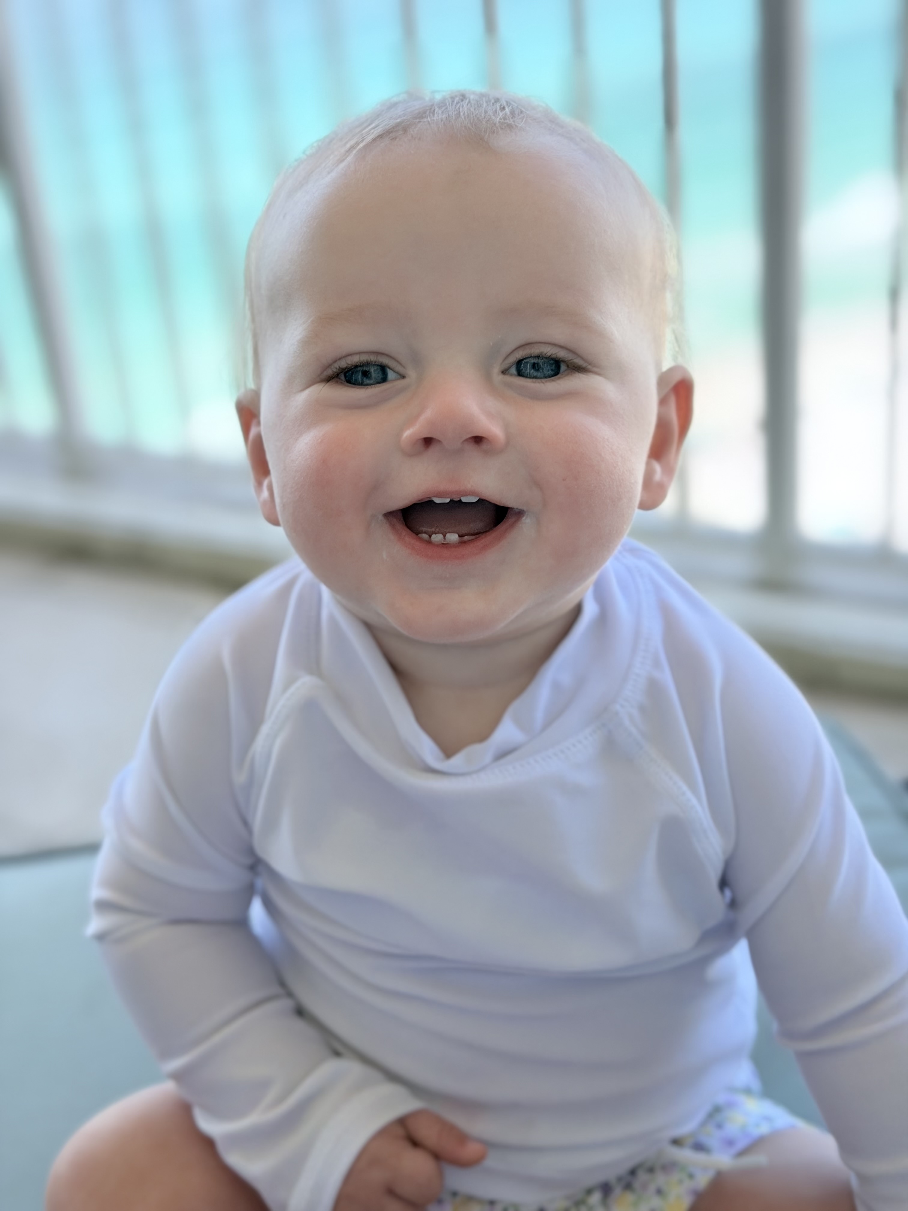 A smiling baby during a family moment