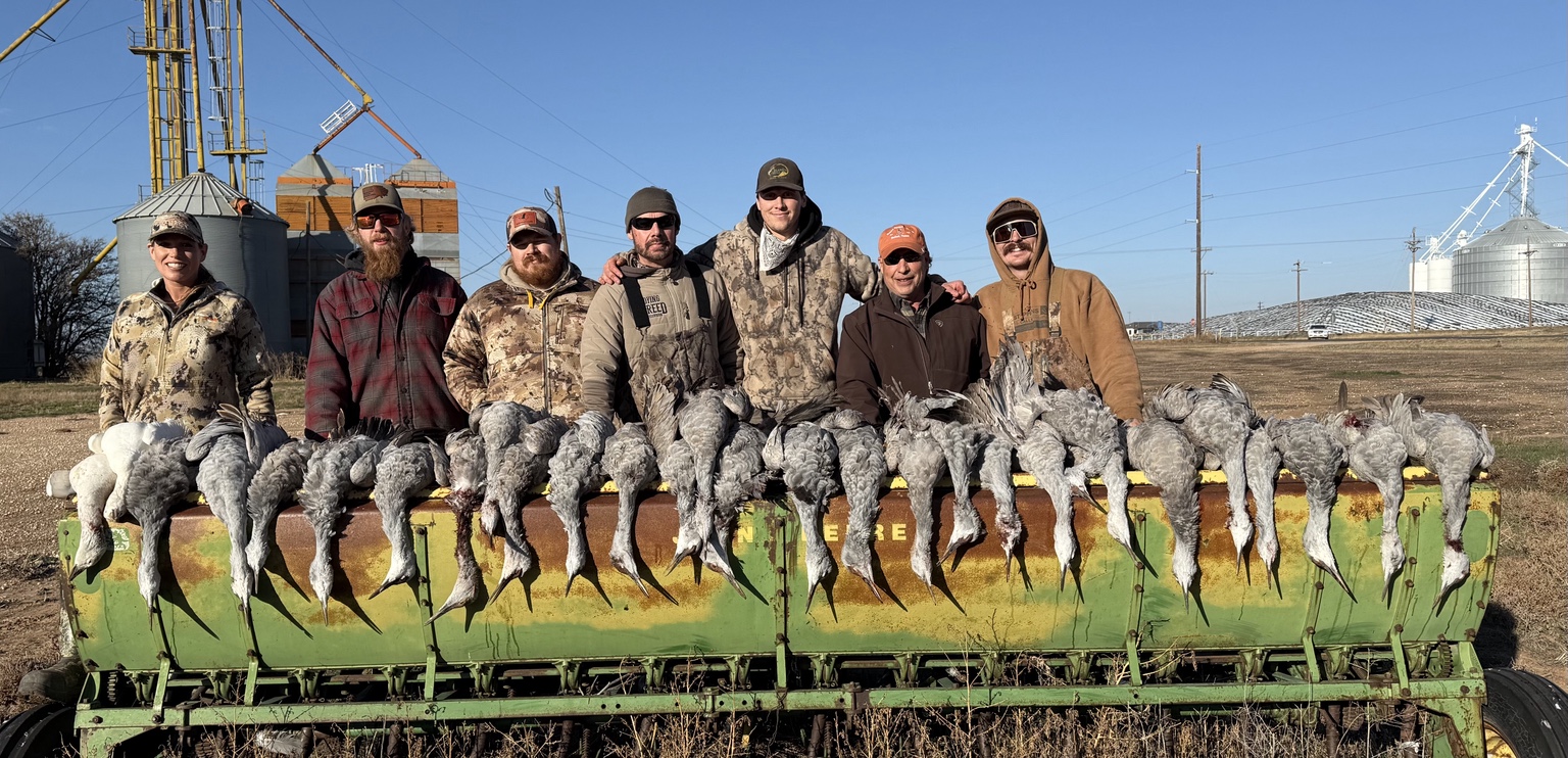 A group gathered with a day's harvest